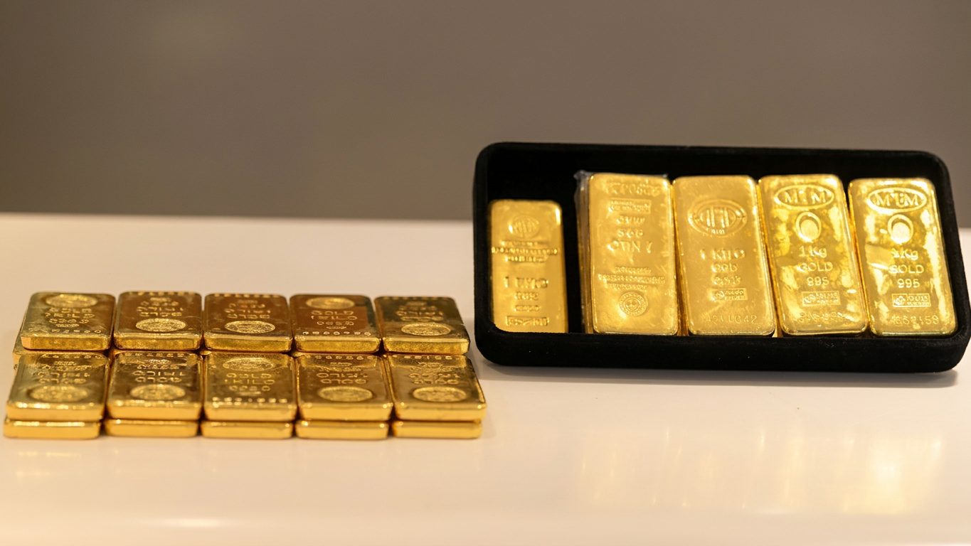 Refined one-kilogram gold bars in a tray and stacked