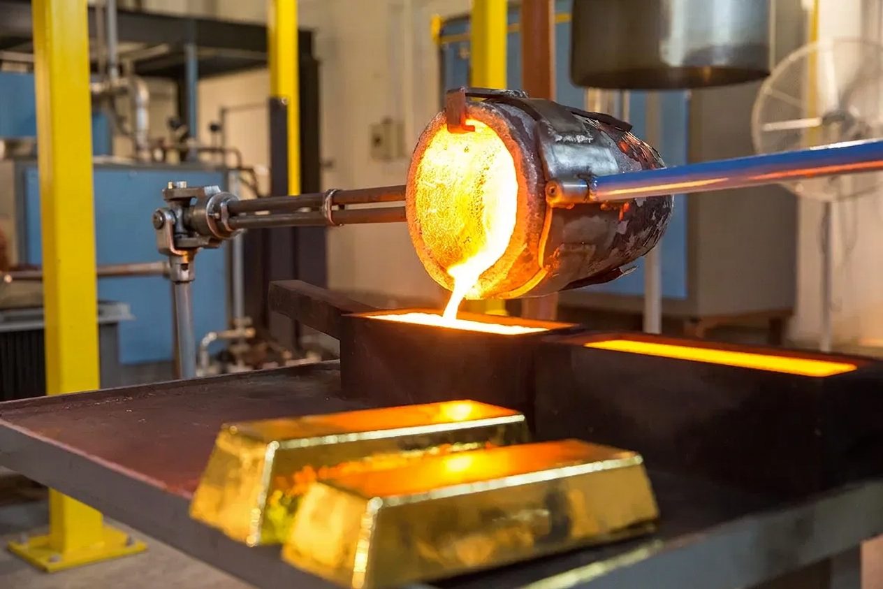 Molten gold poured from a crucible into bar moulds